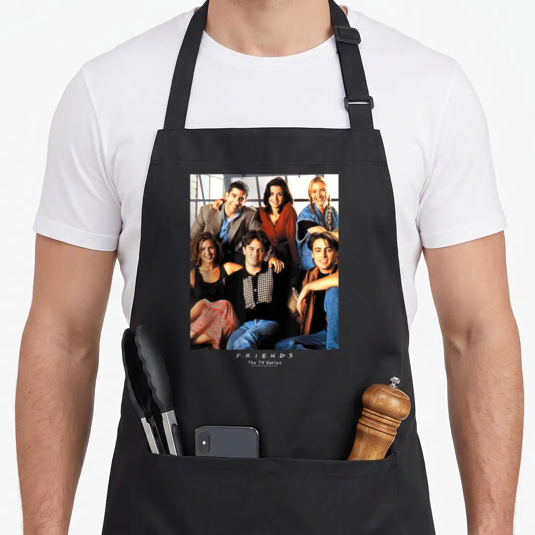 Early friends apron - Photo of six people with stacked F R I E N D S The TV Series text below — shown on a black cotton canvas apron against a white background