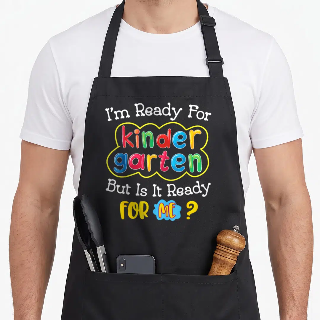 School day kindergarten apron - I'm Ready For kinder garten But Is It Ready FOR ME typography with colorful cloud — shown on a black cotton canvas apron against a white background