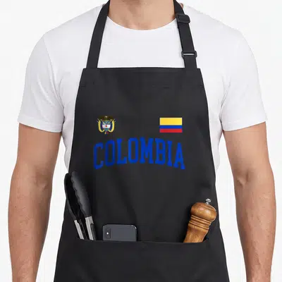 Threadrock pride apron - Colombia coat of arms and flag with arched blue text in blue yellow red — shown on a black cotton canvas apron against a white background