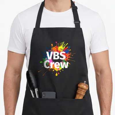 Vbs paint splatter apron - VBS Crew white text over colorful paint splash design — shown on a black cotton canvas apron against a white background