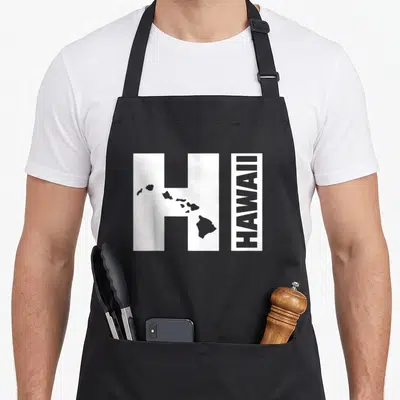 Hawaii island hawaiian apron - White letter H with grey Hawaiian islands silhouette and vertical HAWAII text — shown on a black cotton canvas apron against a white background