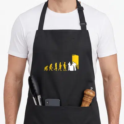 Braumeister craft apron - Yellow and white evolution of man silhouettes ending with brewer pouring grain into barrel — shown on a black cotton canvas apron against a white background