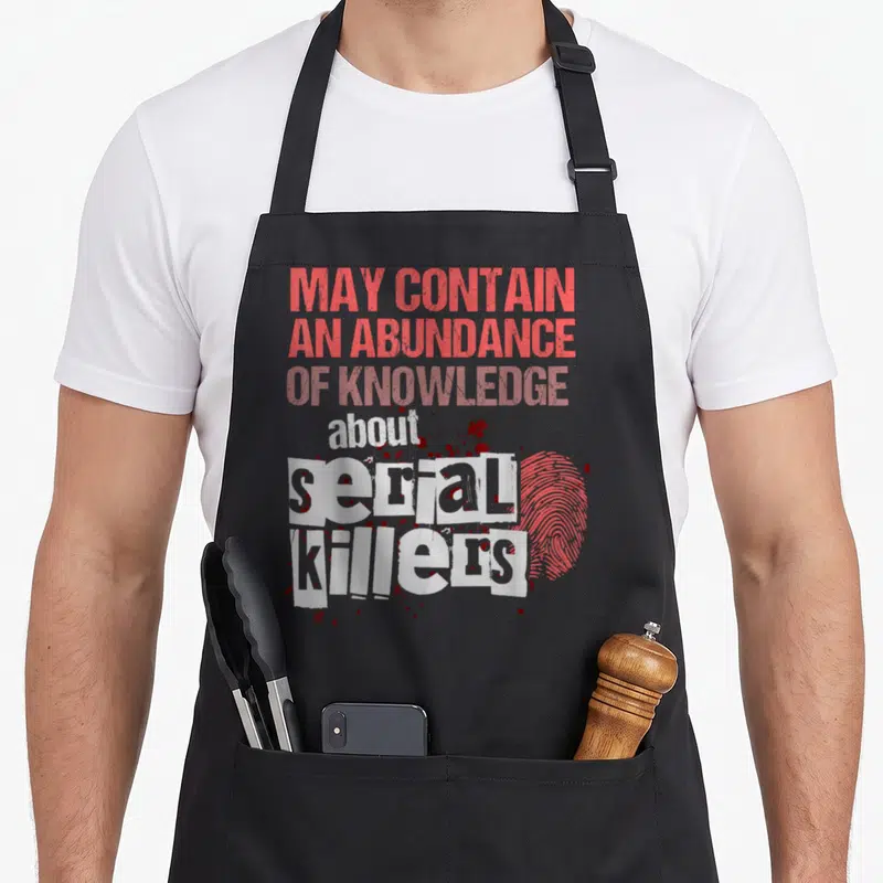 Contain may crazy apron - Red and white text reading may contain abundance of knowledge about serial killers — shown on a black cotton canvas apron against a white background