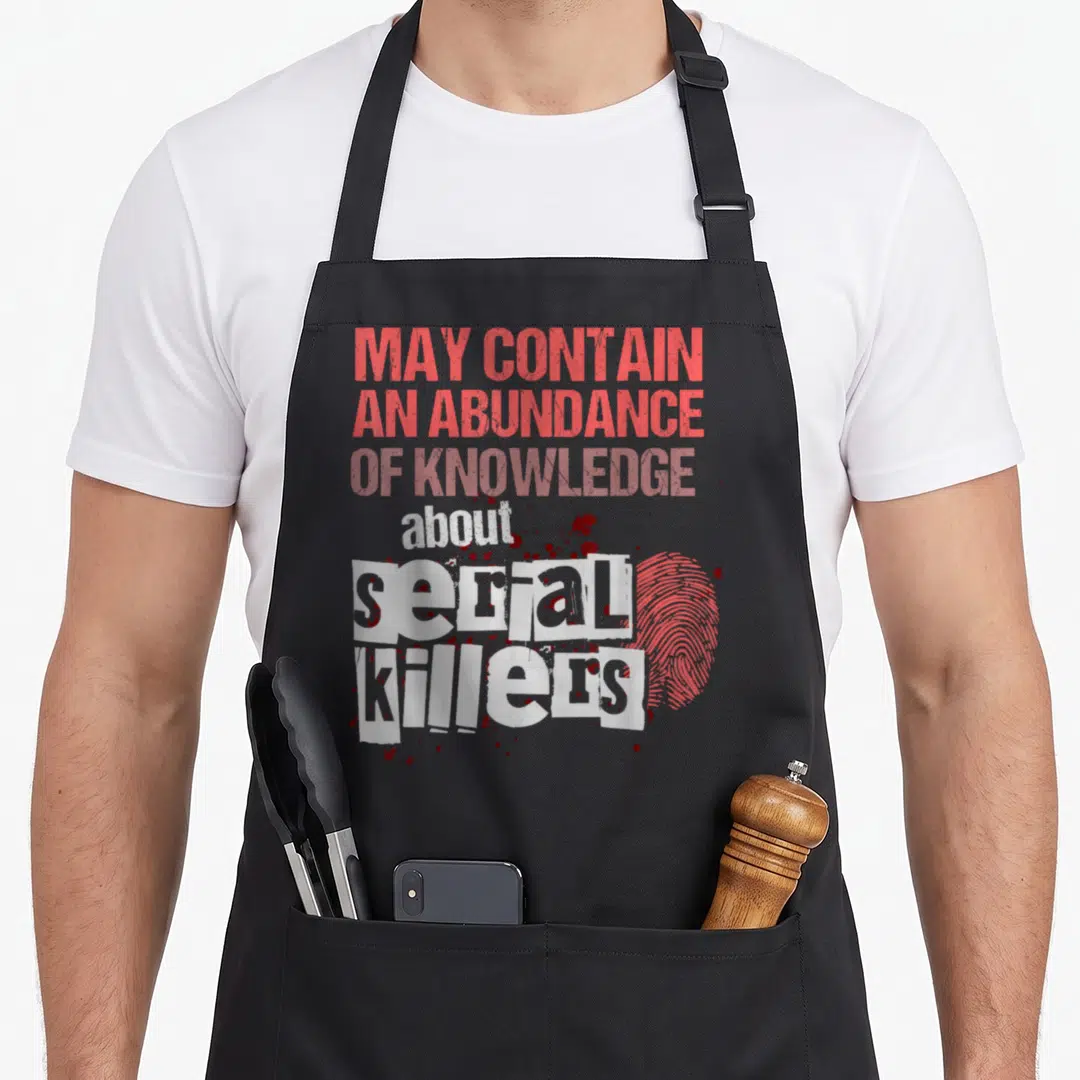 Contain may crazy apron - Red and white text reading may contain abundance of knowledge about serial killers — shown on a black cotton canvas apron against a white background