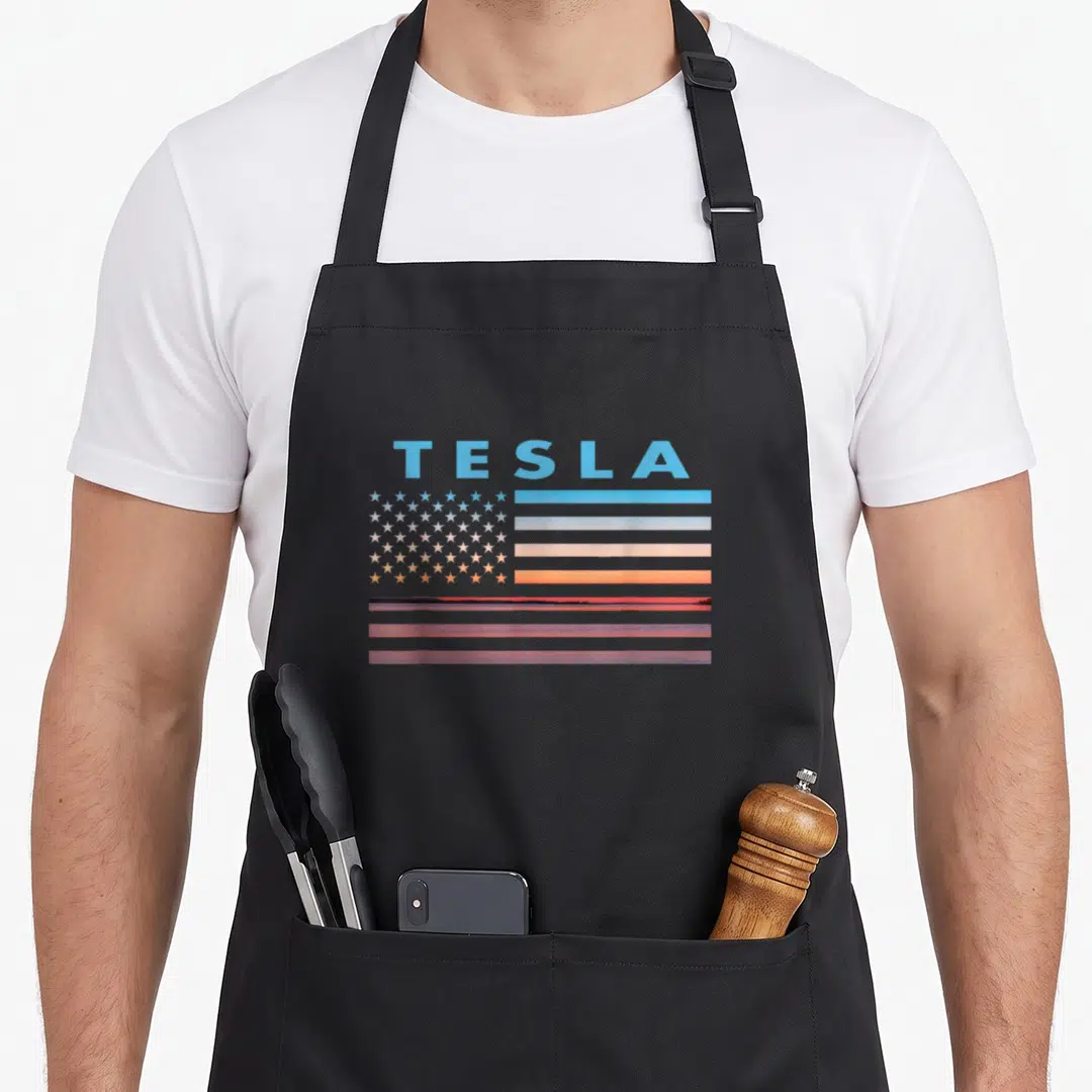 Tesla american flag apron - Stylized flag with sunset stripes and TESLA text representing West Virginia town — shown on a black cotton canvas apron against a white background