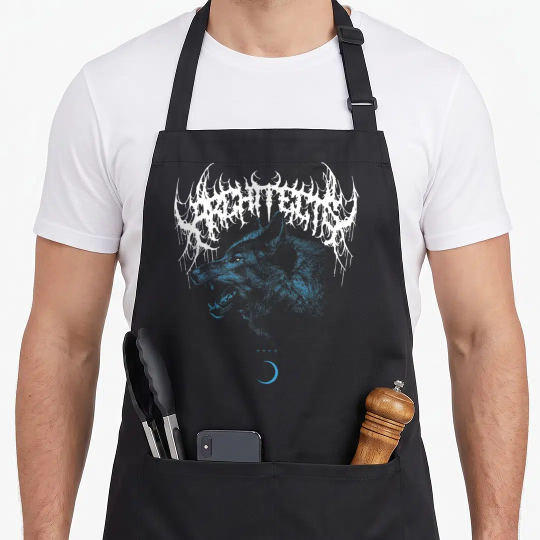 Wolf architect apron - Blue wolf head under white stylized ARCHITECTS text with four crosses and crescent moon — shown on a black cotton canvas apron against a white background
