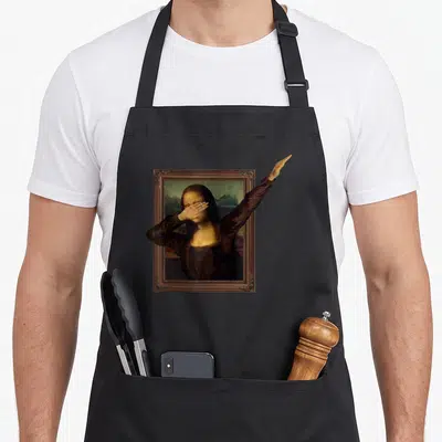 Dabbing mona lisa apron - Realistic painting of Mona Lisa in brown frame with left arm extending outside right edge — shown on a black cotton canvas apron against a white background