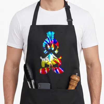 Marvin tie dye apron - Character portrait in red blue yellow white tie-dye with two front pockets — shown on a black cotton canvas apron against a white background