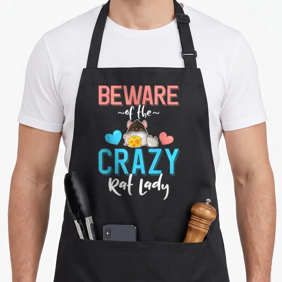 Beware pet apron - Cartoon rat holding cheese between blue and coral hearts with text — shown on a black cotton canvas apron against a white background