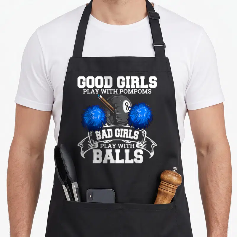 Player pool apron - 8-ball flanked by blue pompoms with Good Girls Play With Pompoms Bad Girls Play With Balls text — shown on a black cotton canvas apron against a white background