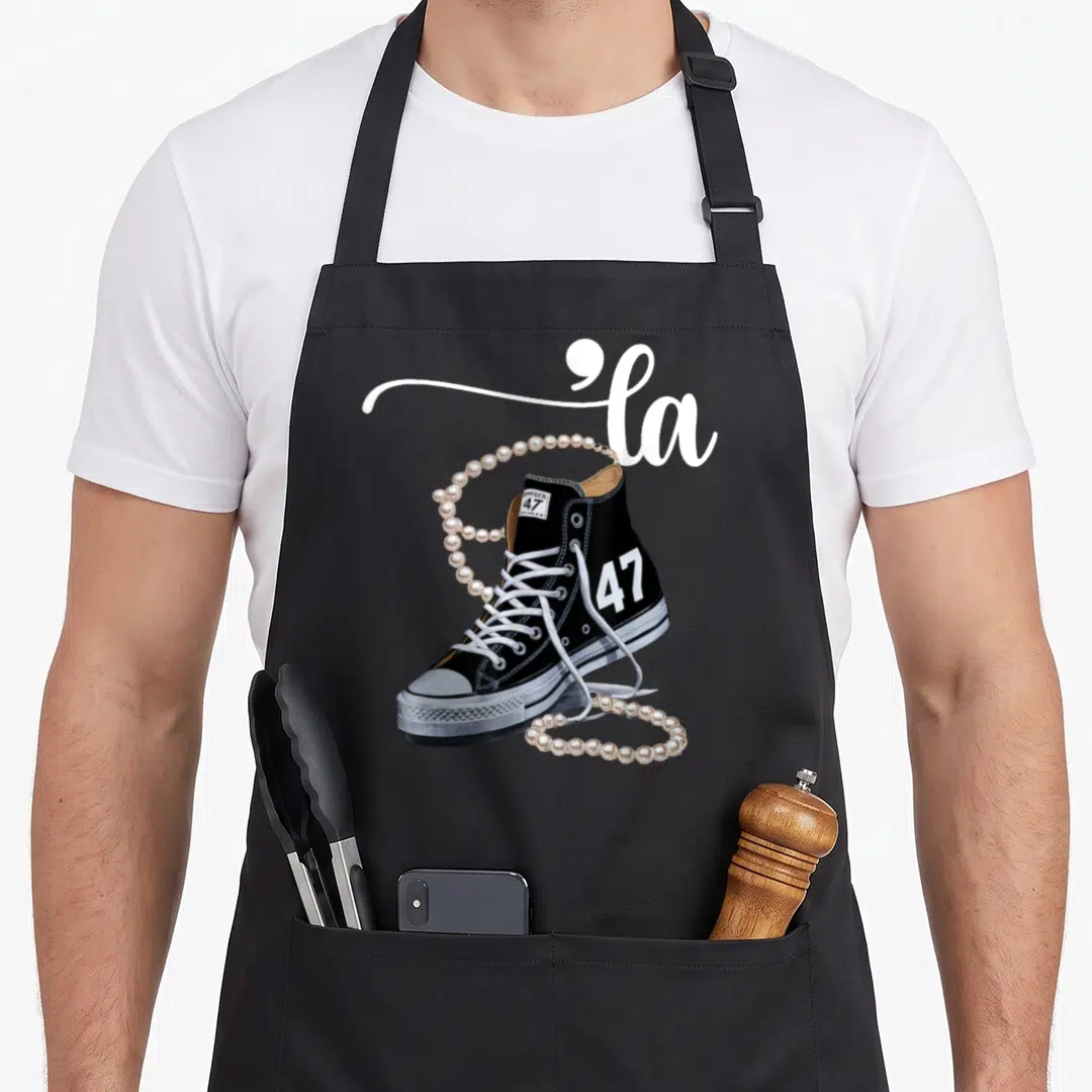 Assignment presidents apron - Black sneaker with la script and 47 number draped in cream pearls — shown on a black cotton canvas apron against a white background