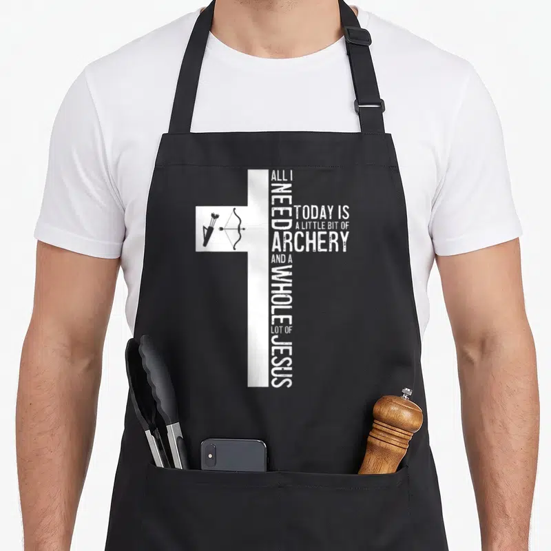 Archery christian apron - White distressed cross formed by text and bow arrows on black fabric — shown on a black cotton canvas apron against a white background