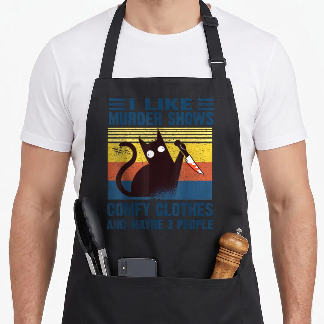 Show local murder apron - Retro black cat holding a bloody knife against blue yellow and orange stripes with text about — shown on a black cotton canvas apron against a white background
