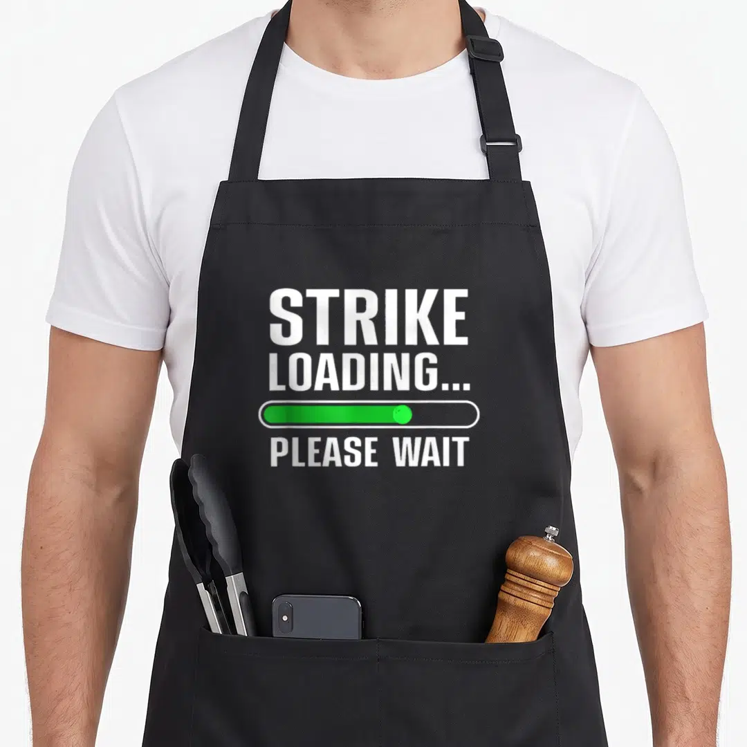 Player bowling apron - White strike loading please wait text with green progress bar — shown on a black cotton canvas apron against a white background