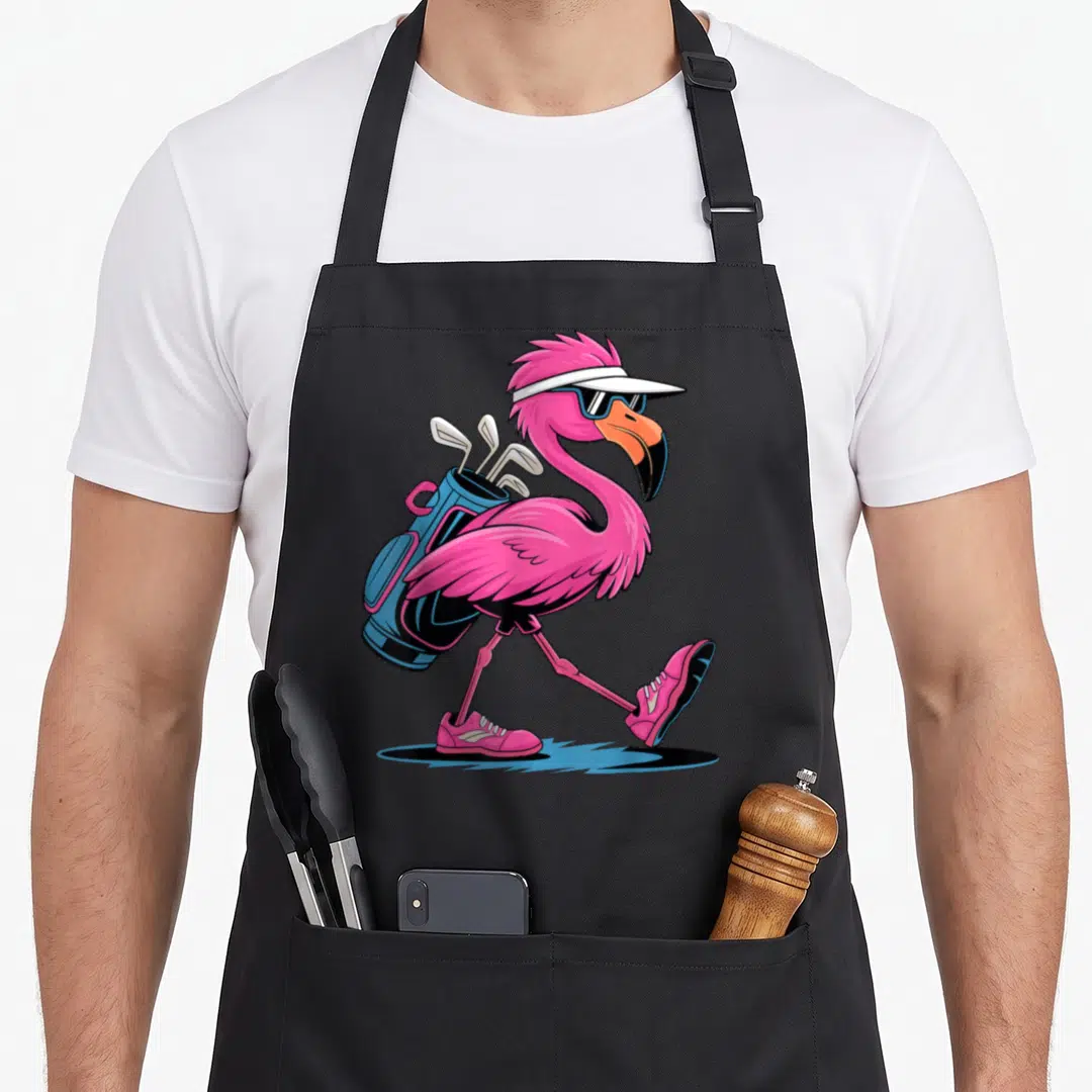 Ping golf apron - Pink flamingo walking with blue golf bag, white visor, and sunglasses — shown on a black cotton canvas apron against a white background