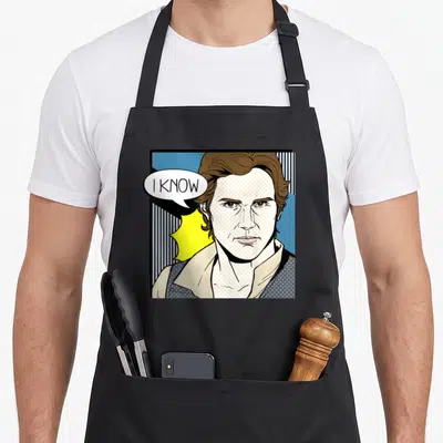Pop valentine's day apron - Pop art man portrait with I KNOW speech bubble on striped blue yellow background — shown on a black cotton canvas apron against a white background