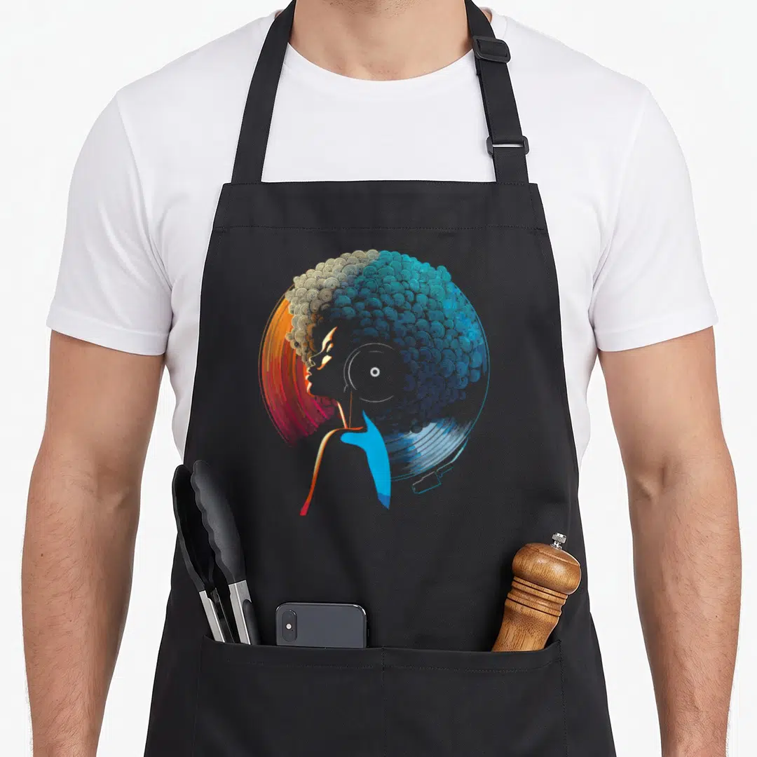 Vinyl african american aprons - Stylized woman profile with afro formed by concentric circles in orange and blue — shown on a black cotton canvas apron against a white background