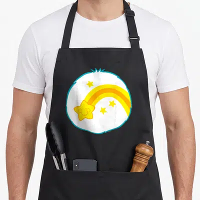 Wish halloween apron - Smiling yellow shooting star with trail inside blue-outlined white circle with three smaller — shown on a black cotton canvas apron against a white background
