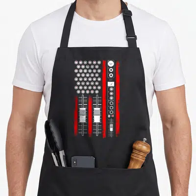 Music producer american flag apron - White and red mixing console graphic with knobs, faders, and technical labels like — shown on a black cotton canvas apron against a white background