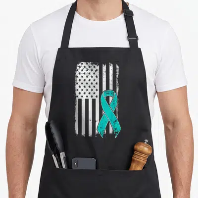Ovarian american flag apron - Teal ribbon overlaying a distressed white American flag design — shown on a black cotton canvas apron against a white background