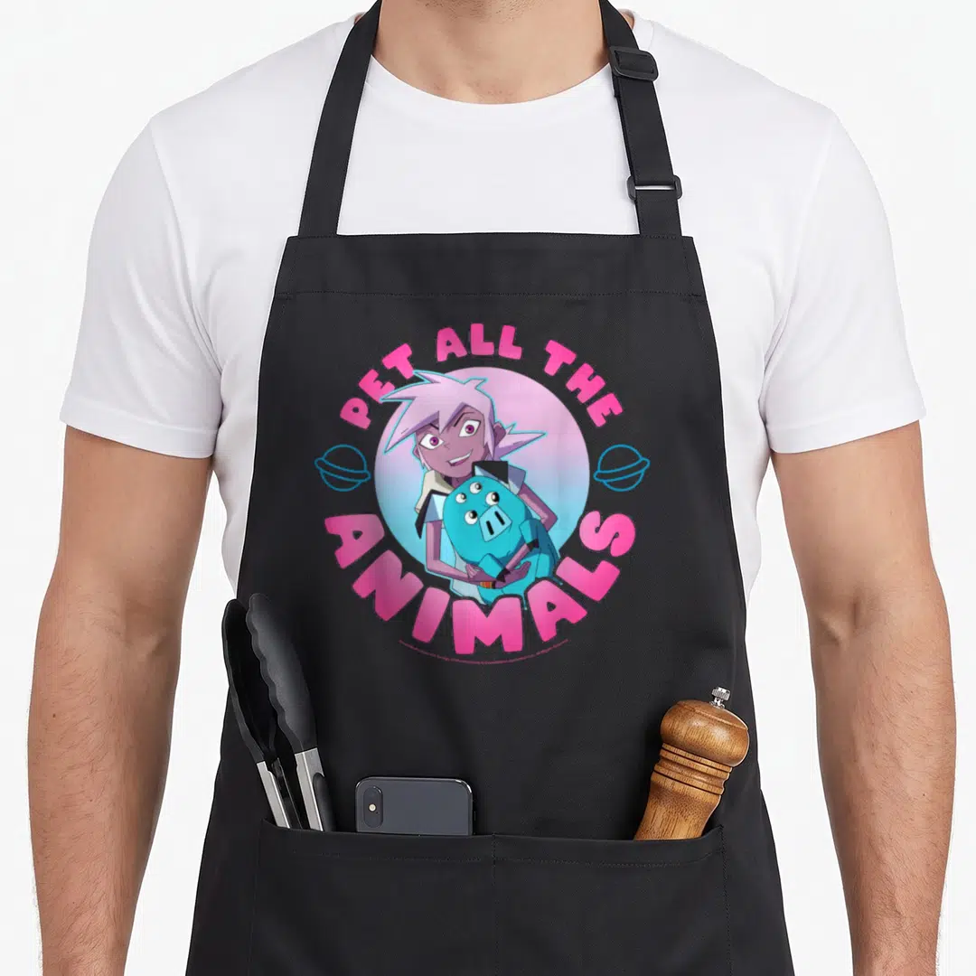 Kipo animal apron - Purple character holding blue multi-eyed creature in gradient circle with pink PET ALL THE ANIMALS — shown on a black cotton canvas apron against a white background