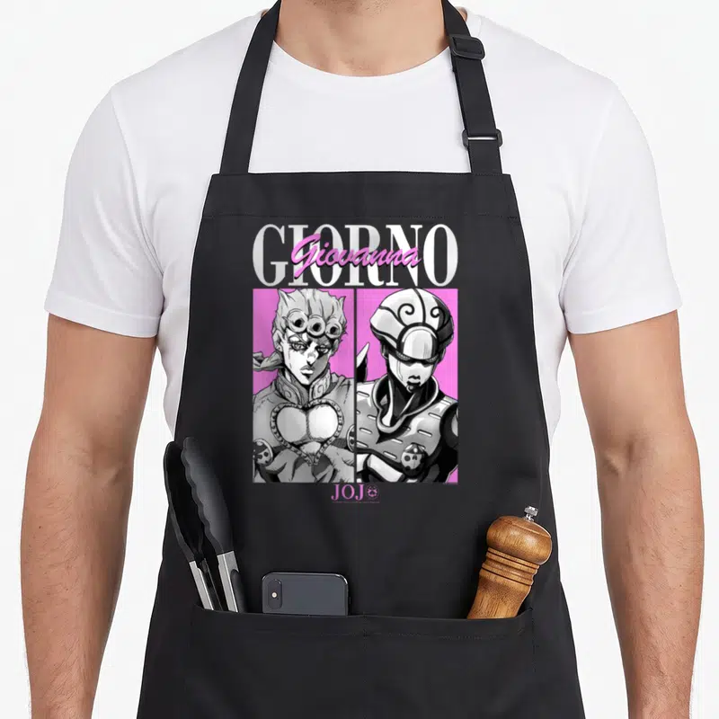 Giorno golden apron - Two grey and black portraits of Giorno Giovanna on pink with GIORNO and JOJO text — shown on a black cotton canvas apron against a white background