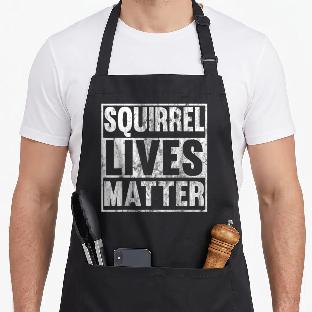 Live squirrel aprons - White distressed text SQUIRREL LIVES MATTER stacked in a rectangular frame on dark background — shown on a black cotton canvas apron against a white background