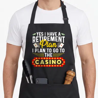 Casino retirement apron - Stacked text yes I have a retirement plan casino sign money cards — shown on a black cotton canvas apron against a white background