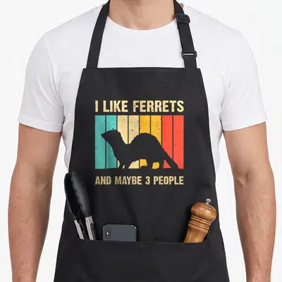 Introvert crazy ferret man apron - Retro ferret silhouette on teal orange and red stripes with beige text — shown on a black cotton canvas apron against a white background
