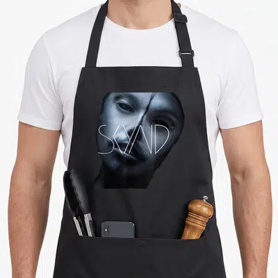 Skynd big band apron - Blue and white photo of a woman's face with SKYND text overlay — shown on a black cotton canvas apron against a white background