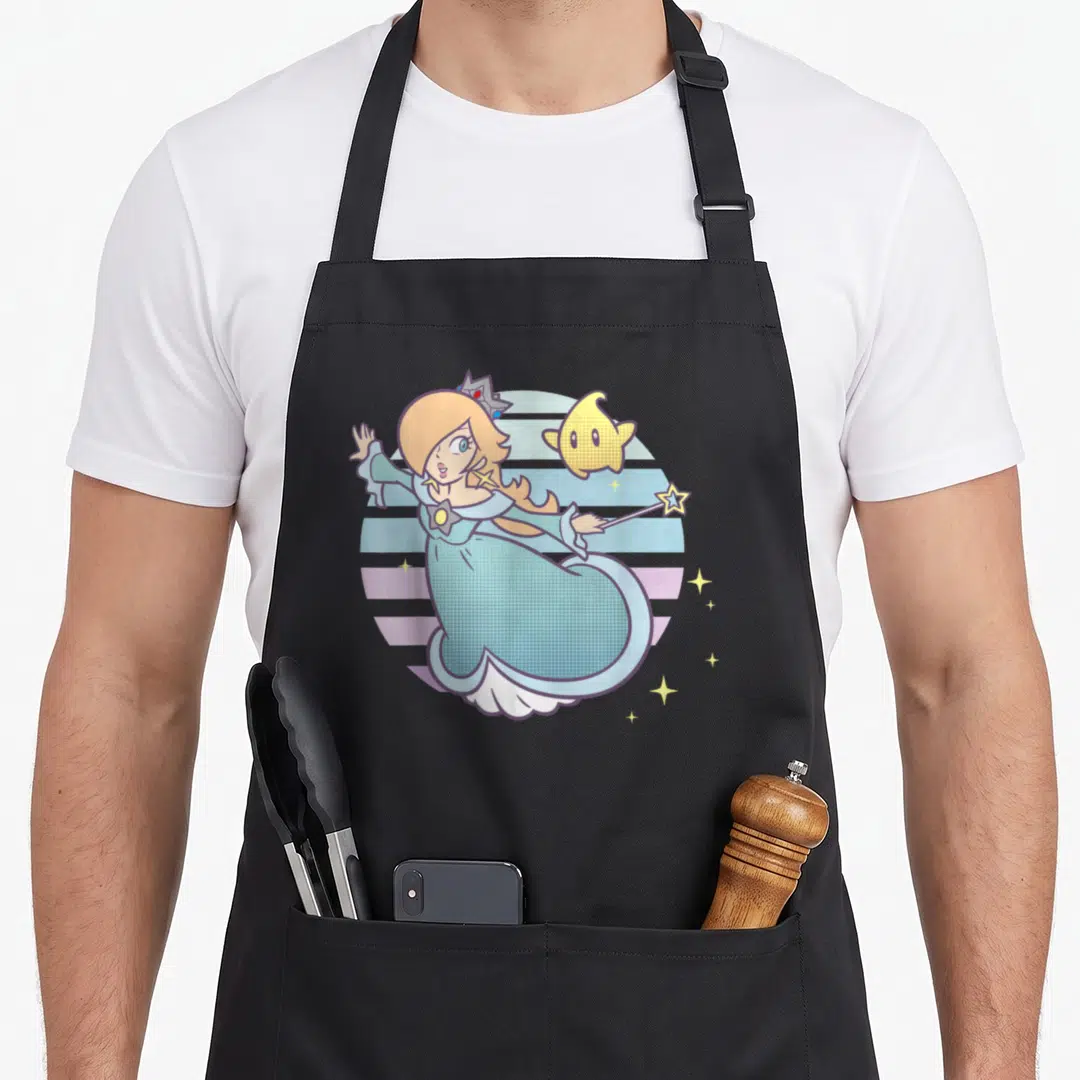 Rosalina striped apron - Cartoon blonde princess holding a star wand next to a yellow floating star on a blue — shown on a black cotton canvas apron against a white background