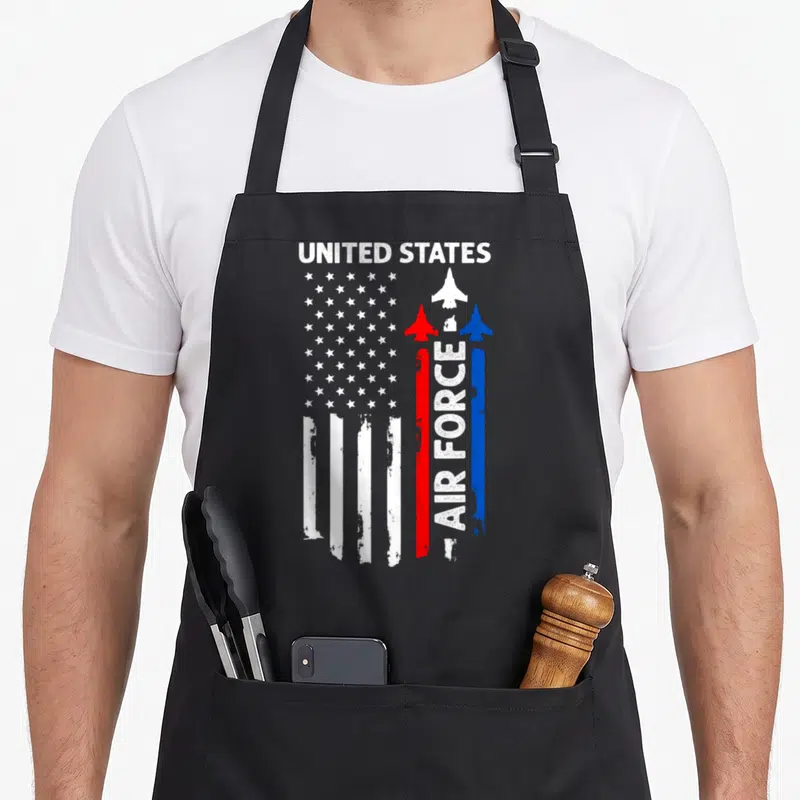 Air 4th of july apron - Distressed US flag split into traditional stripes and three vertical red white blue jets — shown on a black cotton canvas apron against a white background
