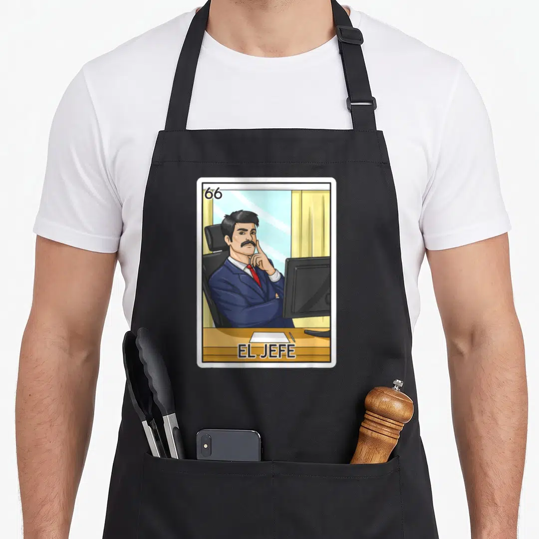 Jefe boss apron - Cartoon man in blue suit with 66 and EL JEFE text in office setting — shown on a black cotton canvas apron against a white background