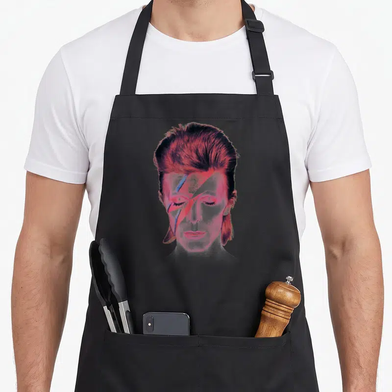 Prettiest david aprons - Stylized male portrait with pink, red, and blue lightning bolt across eyes — shown on a black cotton canvas apron against a white background