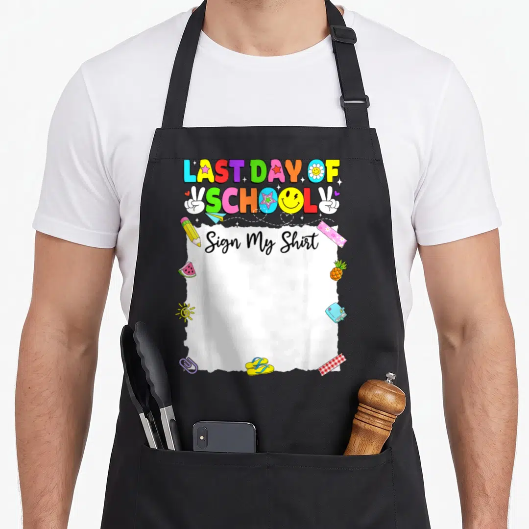 Sign school graduation apron - Last Day of School text above white torn paper with Sign My Shirt surrounded by colorful — shown on a black cotton canvas apron against a white background