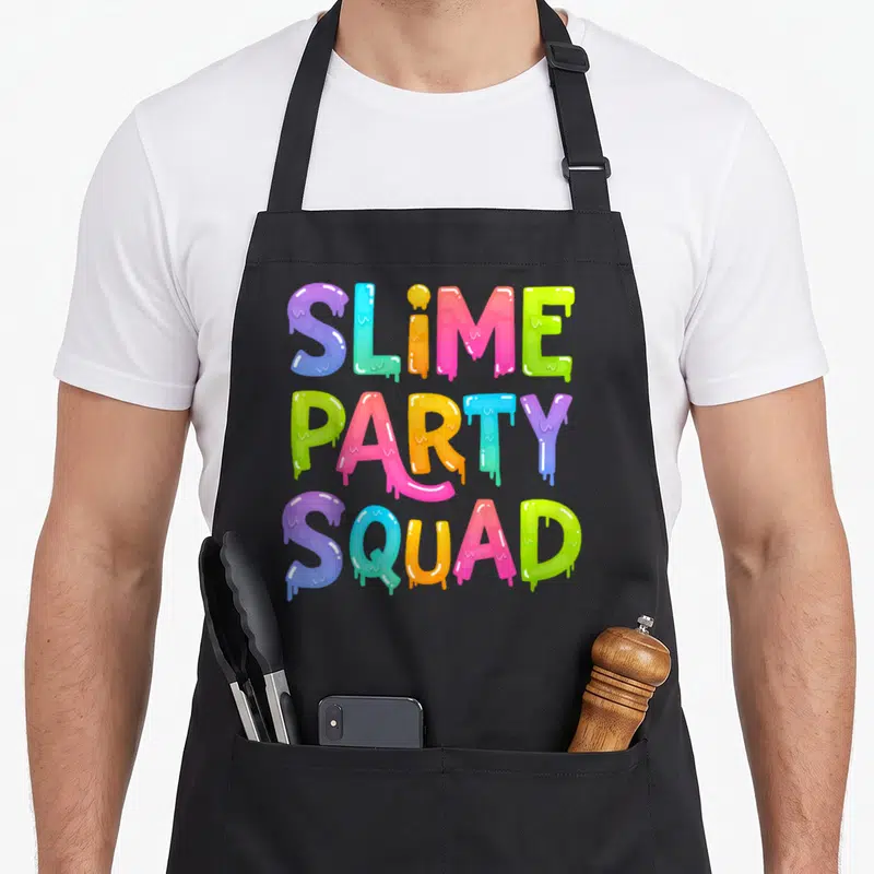 Slime birthday apron - Dripping multicolor typography reading SLIME PARTY SQUAD stacked vertically — shown on a black cotton canvas apron against a white background