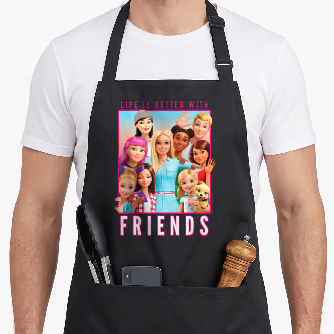 Dreamhouse friends apron - LIFE IS BETTER WITH FRIENDS text above cartoon group inside pink frame with dog — shown on a black cotton canvas apron against a white background
