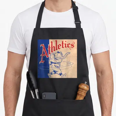 Philadelphia baseball apron - Red Athletics text above cartoon elephant in baseball uniform on split blue tan background — shown on a black cotton canvas apron against a white background