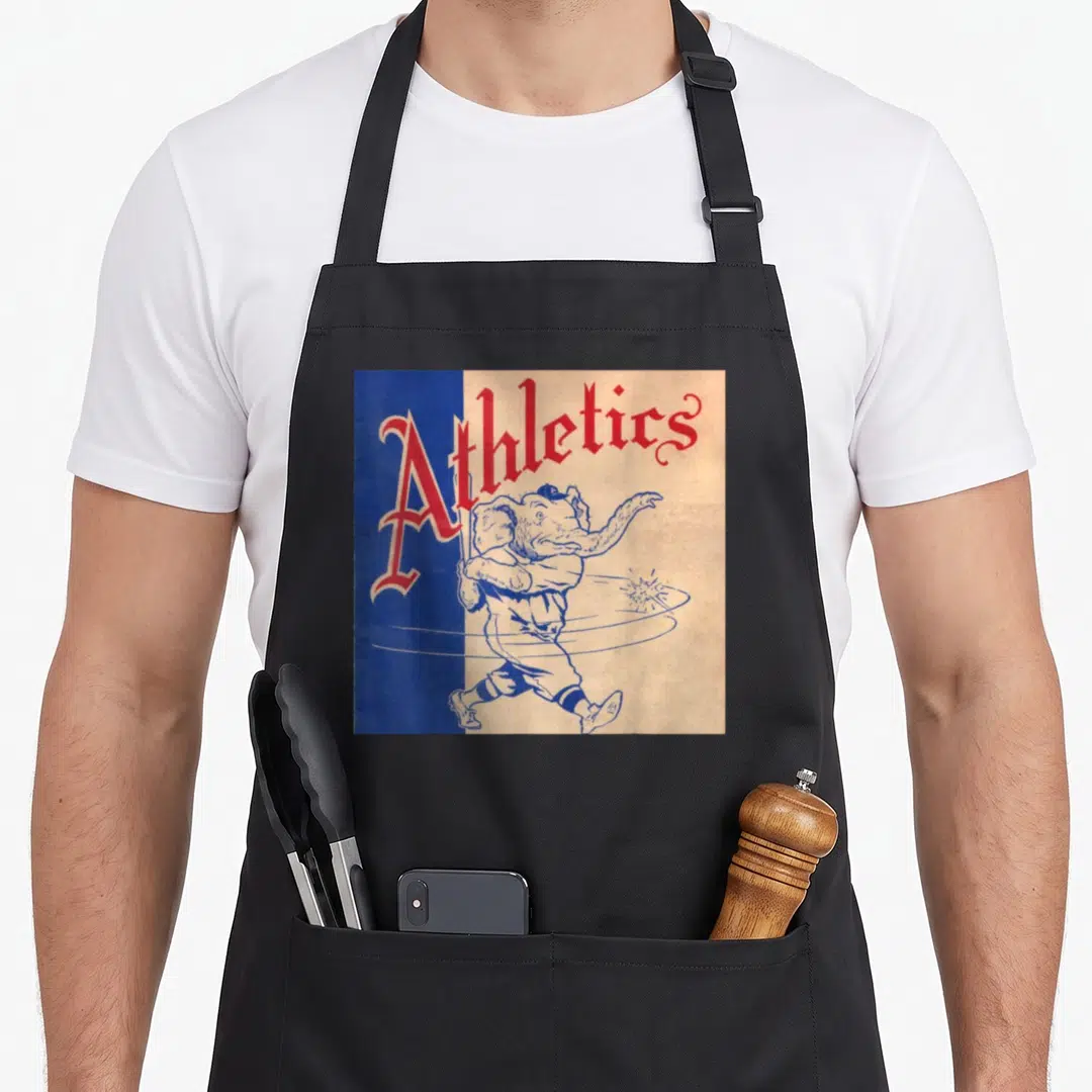 Philadelphia baseball apron - Red Athletics text above cartoon elephant in baseball uniform on split blue tan background — shown on a black cotton canvas apron against a white background