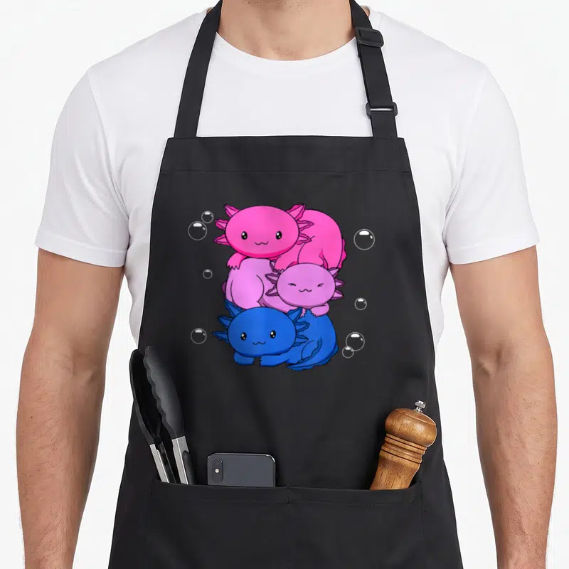 Bisexual kawaii apron - Three cartoon axolotls stacked vertically in pink, purple, and blue with white bubbles — shown on a black cotton canvas apron against a white background