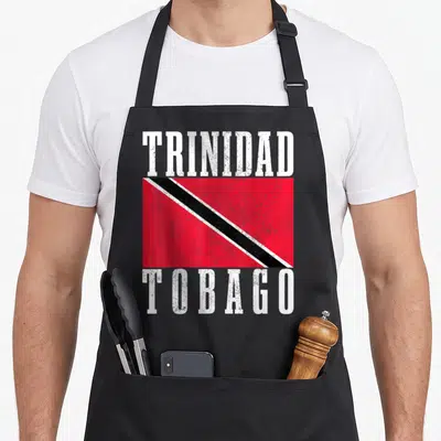 Tobago trinidadian boy apron - Distressed Trinidad Tobago flag print with white text above and below red black white — shown on a black cotton canvas apron against a white background