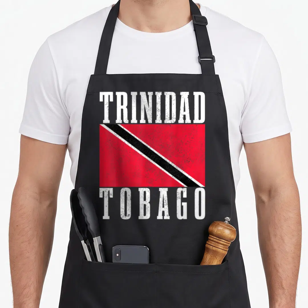 Tobago trinidadian boy apron - Distressed Trinidad Tobago flag print with white text above and below red black white — shown on a black cotton canvas apron against a white background