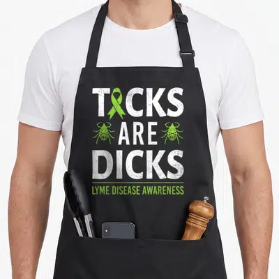 Tick ribbon apron - Distressed white text reading TICKS ARE DICKS with lime green ribbon and two tick icons above Lyme — shown on a black cotton canvas apron against a white background