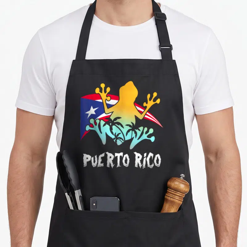 Distressed puerto frog aprons - Gradient frog silhouette over waving flag with palm trees and distressed PUERTO RICO — shown on a black cotton canvas apron against a white background