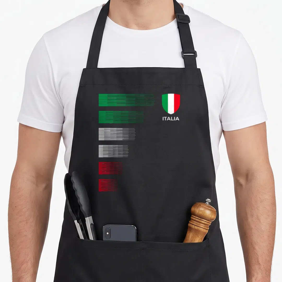 Italia italian aprons - Minimalist shield with green white red stripes and Italia text beside stacked colored lines — shown on a black cotton canvas apron against a white background