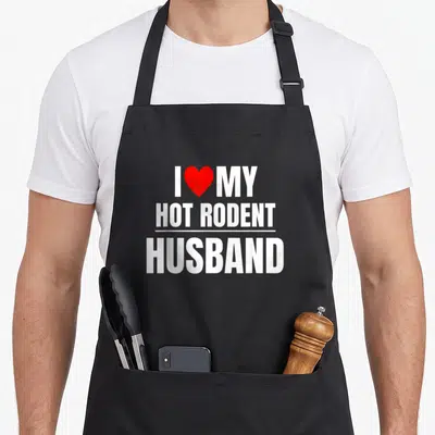 Hot rodent husband apron - White text reading I heart My Hot Rodent Husband with red heart icon — shown on a black cotton canvas apron against a white background