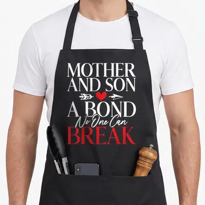 Bond mother son aprons - MOTHER AND SON A BOND No One Can BREAK text with red heart and white arrow — shown on a black cotton canvas apron against a white background
