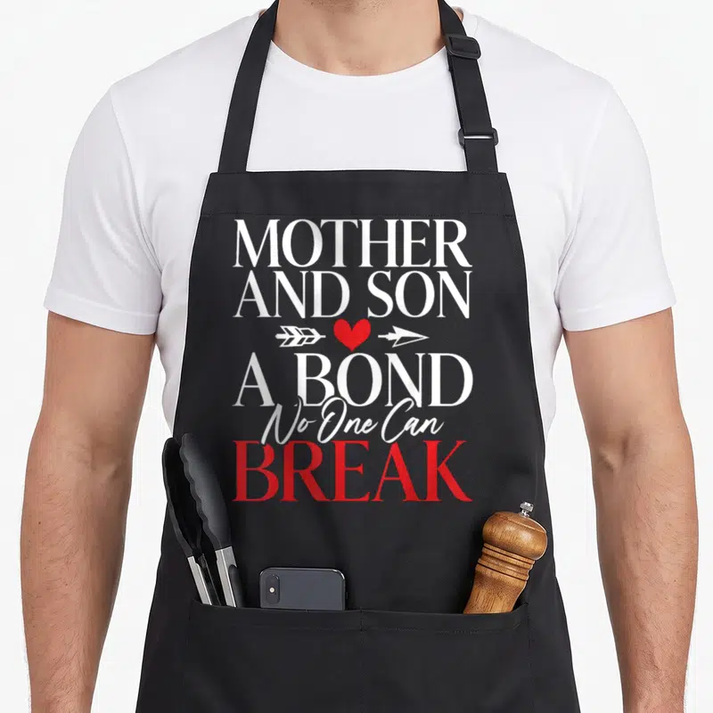 Bond mother son aprons - MOTHER AND SON A BOND No One Can BREAK text with red heart and white arrow — shown on a black cotton canvas apron against a white background