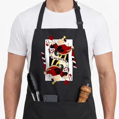 Alice queen apron - Queen of Hearts playing card design with Off With Their Heads text in red black white and yellow — shown on a black cotton canvas apron against a white background