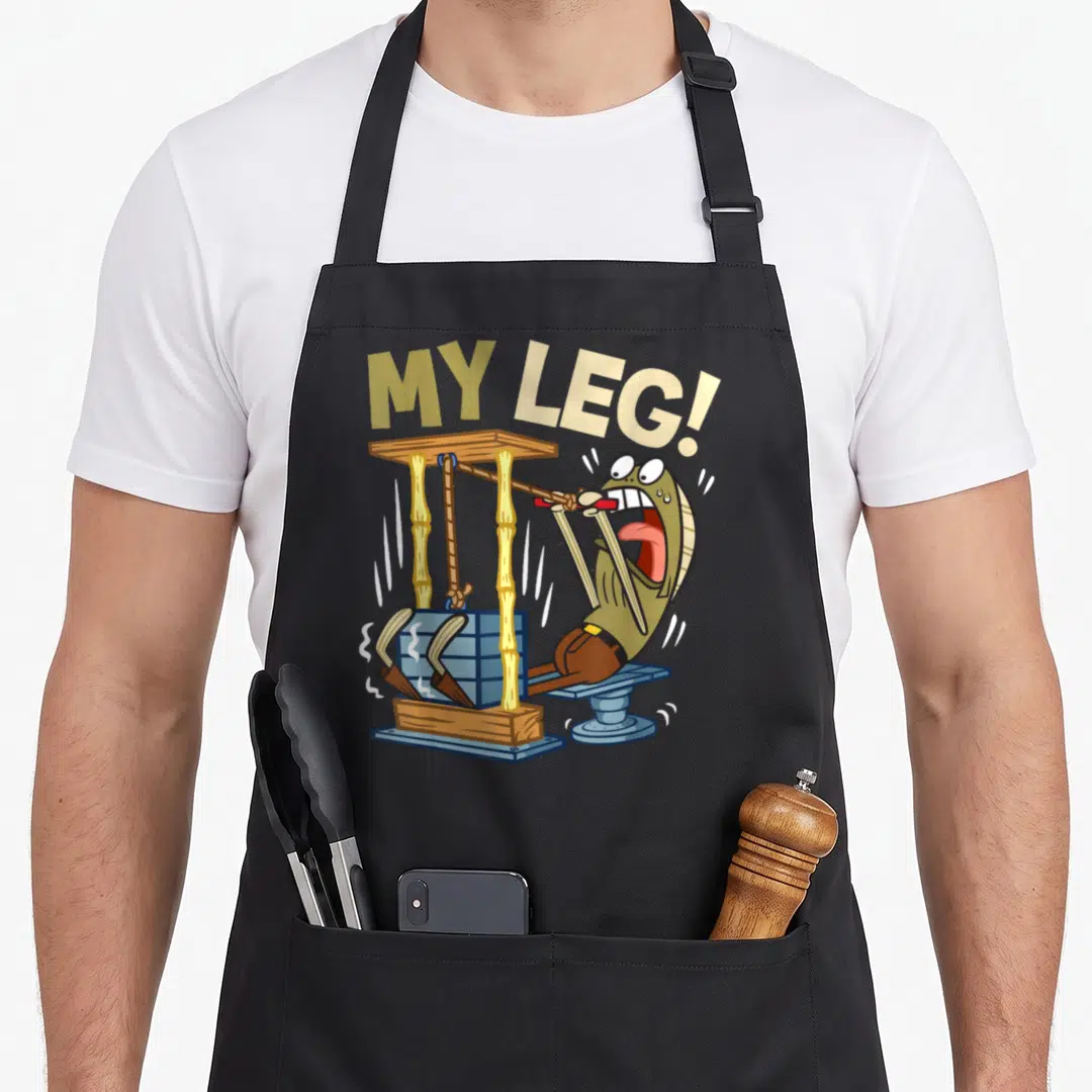 Weight leg apron - Cartoon fish screaming on leg press machine under MY LEG! text — shown on a black cotton canvas apron against a white background